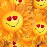 A group of yellow sunflower-like faces with heart-shaped eyes and smiling mouths, arranged closely together in a cheerful pattern, evokes playful Metaphors of Movement and joy. | Andrew T. Austin | Metaphors of Movement