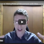 Mark Andreas, wearing glasses, gestures with both hands whilst speaking during a webinar video call, seated in front of wooden walls. | Andrew T. Austin | Metaphors of Movement