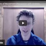 A person with curly hair sits in front of a wooden wall, speaking during a YouTube video titled MoM Discussion: Metaphors of Movement with Andrew T. Austin. | Andrew T. Austin | Metaphors of Movement