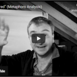 A man with short hair gestures with raised hands in front of a whiteboard in the black and white new video titled Untethered (Metaphor Analysis). | Andrew T. Austin | Metaphors of Movement